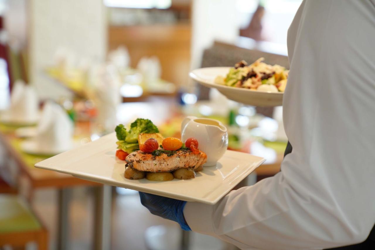 Majestic Arjaan By Rotana - Manama Aparthotel Ngoại thất bức ảnh A waiter serving food